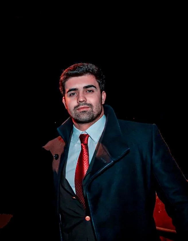 Berto Barata, de fato e sobretudo, num retrato noturno em Lisboa